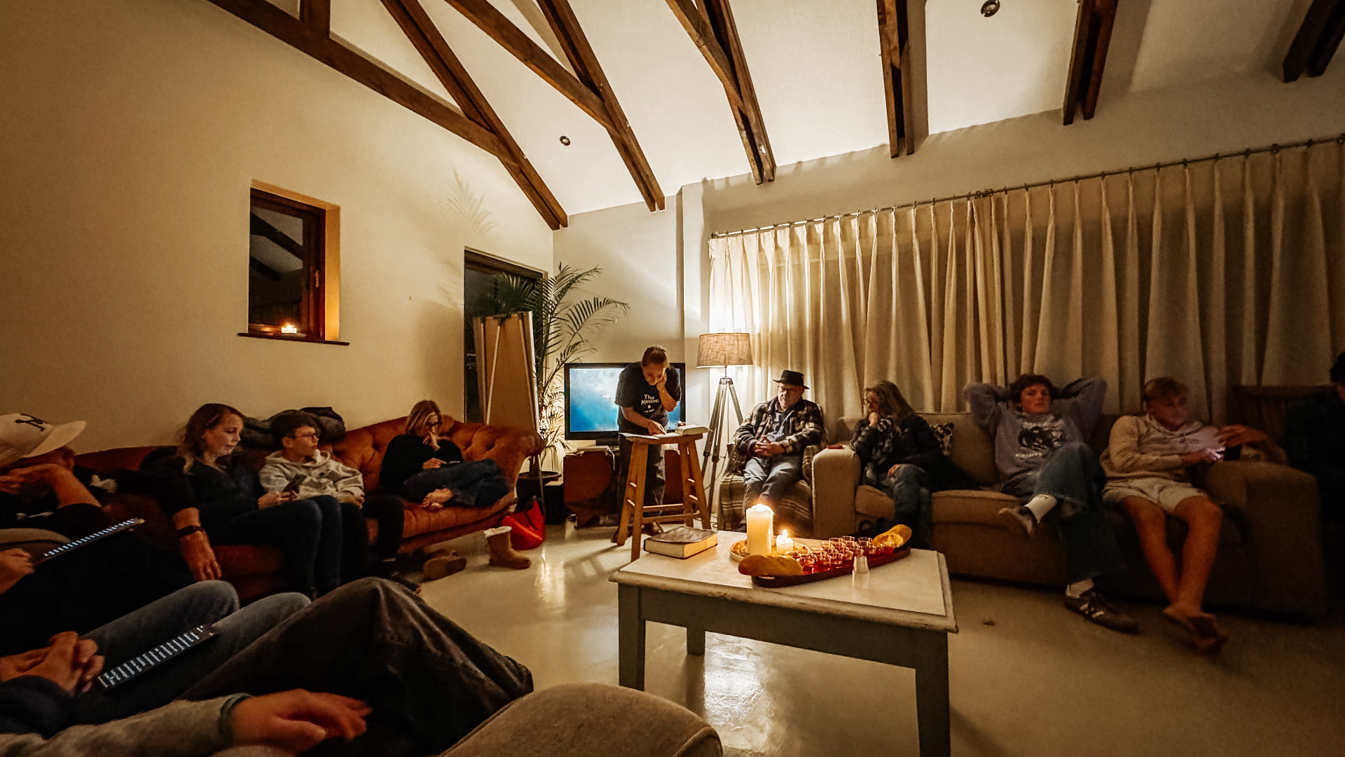 A home gathering sharing communion around the table