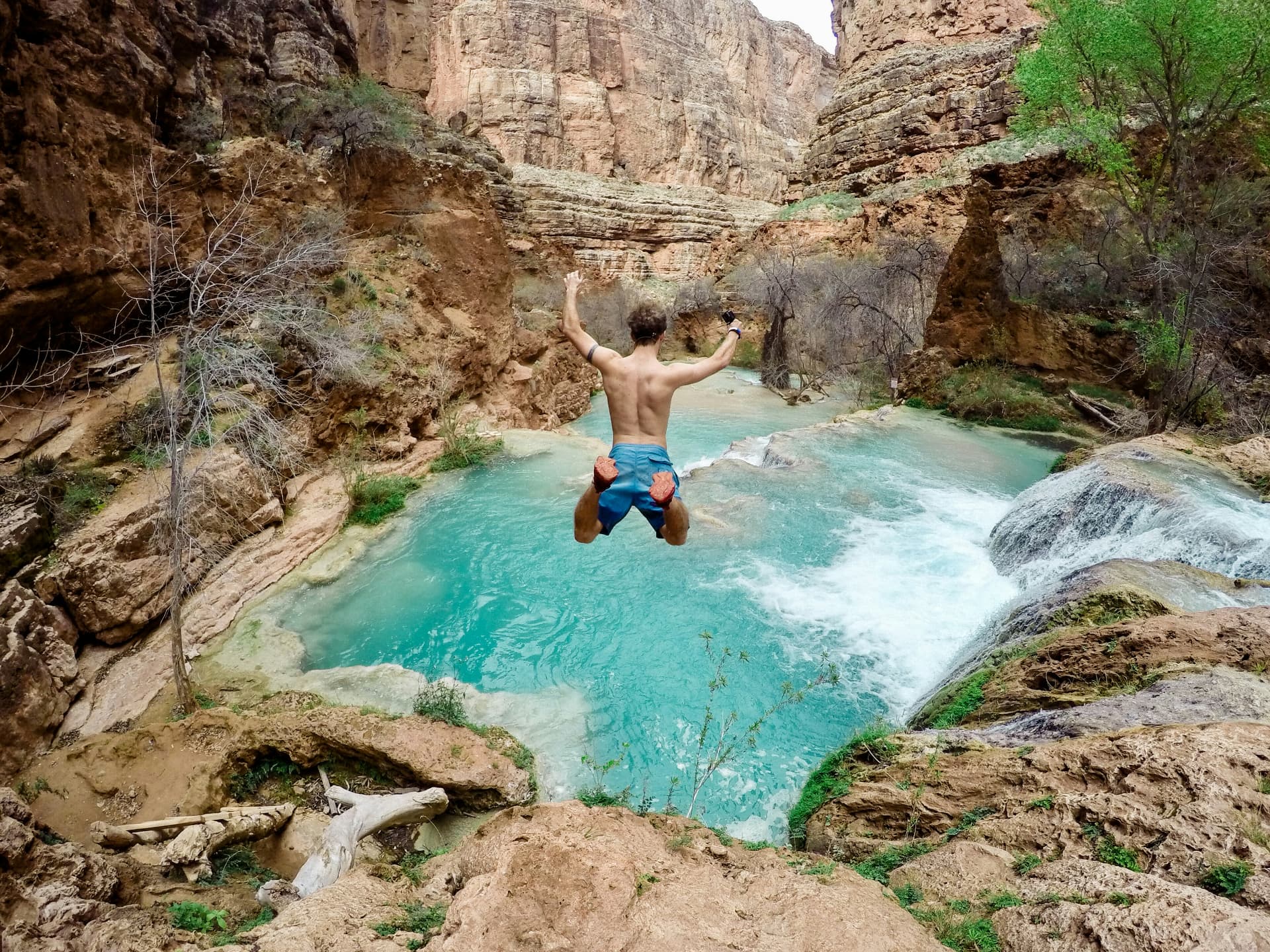 A student leaping across a canyon gap